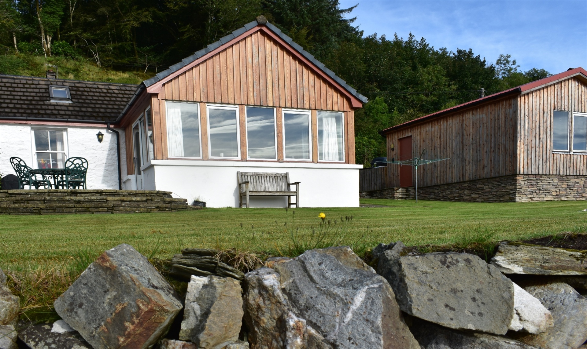 The Wee Barn exterior overlooking the garden and bay