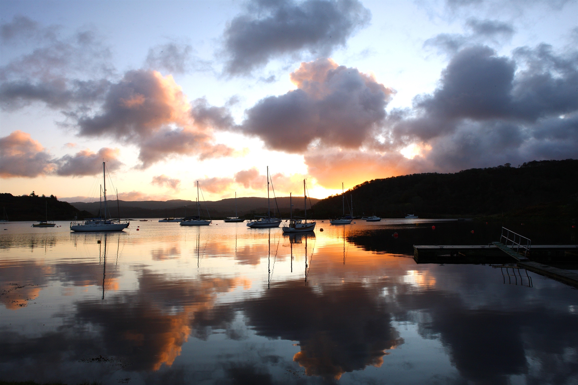 Sunrise over the moored boats in Tayvallich Bay